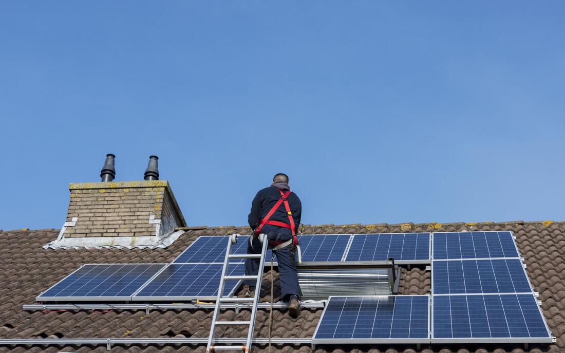 worker checking the solar panels